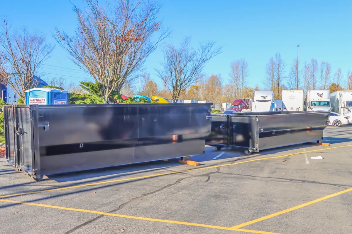 Professional dumpster rental service with roll-off container on residential driveway in Big Bear City